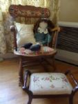 ANTIQUE OAK ROCKER CHAIR WITH UPHOLSTERED SEAT AND BACK. NEEDLE POINT FOOT STOOL,  LARGE RAG DOLL
