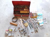 RED METAL TOOL BOX WITH APPROX. 80 TO 100 DRILL BITS, STAPLER, RACHET, SOCKETS AND MUCH MORE