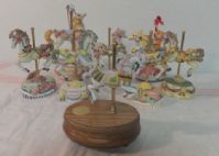 A MERRY GO ROUNDLESS COLLECTION OF MUSIC BOX CAROUSEL HORSES  (8)