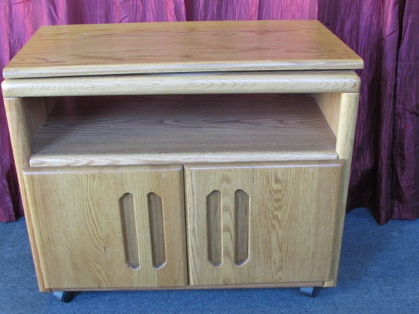 STURDY OAK ROLLING CABINET WITH ROTATING TOP