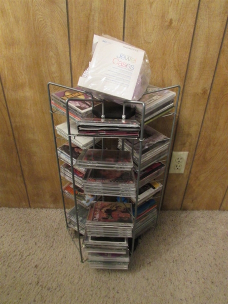 LARGE ASSORTMENT OF CDS ON STAND & EXTRA CASES
