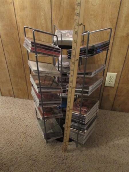 LARGE ASSORTMENT OF CDS ON STAND & EXTRA CASES